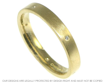 18ct yellow gold band with five 1mm brilliant cut diamonds.
