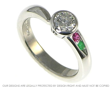 Bespoke platinum asymmetrical engagement ring with diamond,ruby and emerald.