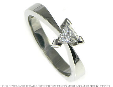 Platinum engagement ring with trillion cut diamond.