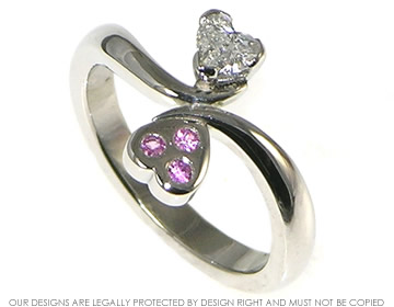 Platinum engagement ring with a heart shaped diamond and pink sapphire 