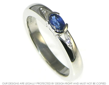 Bespoke platinum engagement ring with central oval cut blue sapphire 