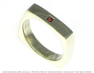 Bespoke 9ct white gold commitment ring with a princess cut garnet