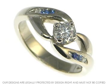 Bespoke 18ct white gold engagement ring with diamonds and sapphires.