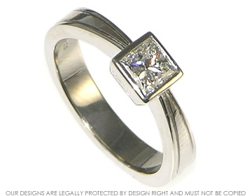 Bespoke platinum engagement ring with princess cut diamond and engraved detail 