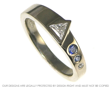 Bespoke engagement ring with trillion cut diamond and sapphires. 