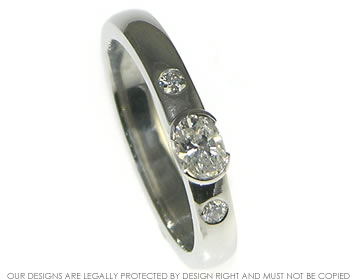 Bespoke platinum engagement ring with a recycled oval cut diamond.