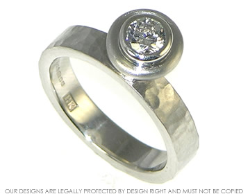 Bespoke platinum engagament ring with a hammered finish