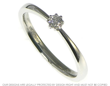 Very delicate platinum solitaire engagement ring with a tapered shank  