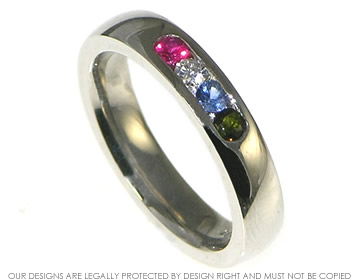 A Palladium channel set coloured stoned eternity ring. 