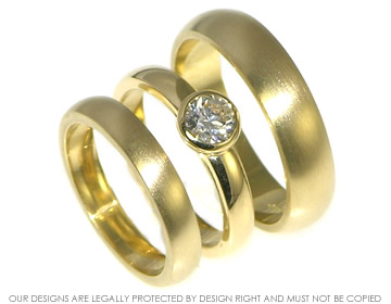 Matching set of  wedding bands in 3.5mm and 5mm 18ct yellow gold with a satinised finish.