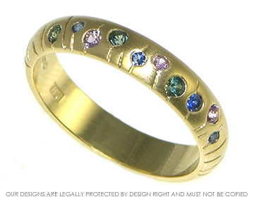 18ct yellow gold eternity ring with scattered set sapphires