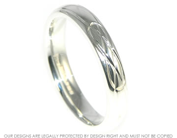 Sterling silver wedding ring with a celtic style engraving. 