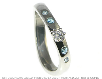 Bespoke sailing inspired palladium, diamond and topaz engagement ring.