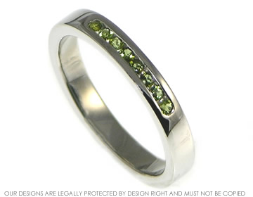 Palladium eternity ring with 8 vivid green tourmalines channel set into the band