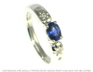 Bespoke 9ct white gold engagement ring with an oval sapphire and diamonds