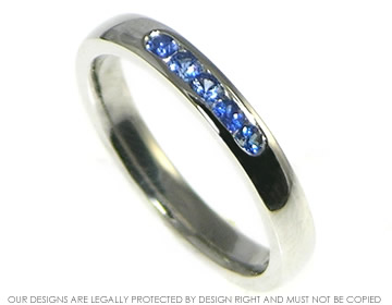 Platinum blue sapphire eternity ring with a soft courting profile