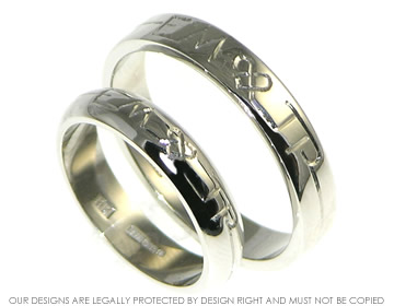 Palladium wedding rings with engraved detail.