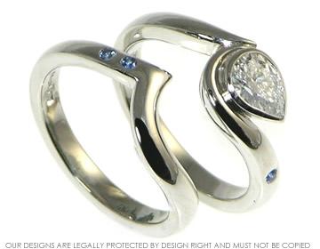 Fitted platinum wedding ring with two 1.5mm brilliant cut blue sapphires.