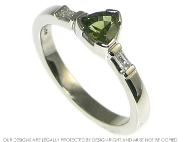 Platinum engagement ring with a green sapphire and diamonds