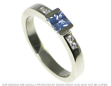 Palladium engagement ring with a princess cut sapphire and diamonds. 