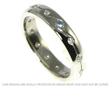 A platinum and diamond aqauamarine wedding ring. 