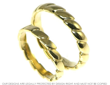 A pair of twist style 18ct yellow gold wedding bands. 