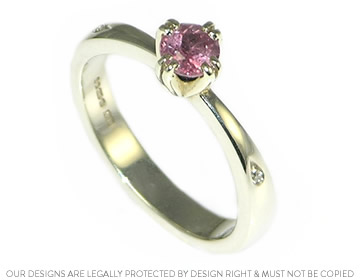 Simple 9ct white gold engagement ring with pink sapphire and shoulder set diamonds