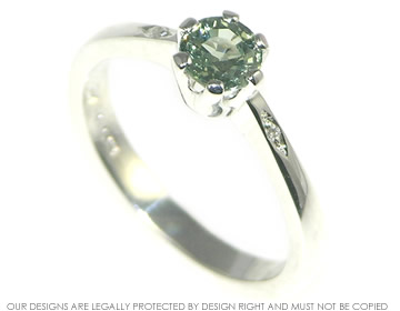 Sterling silver engagement ring with a six claw set green sapphire