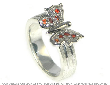 Butterfly inspired Silver and palladium Dress ring with Garnets.