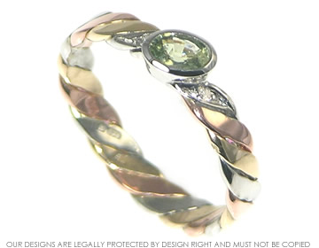 Hand-plaited Celtic twist band with green sapphire and diamonds