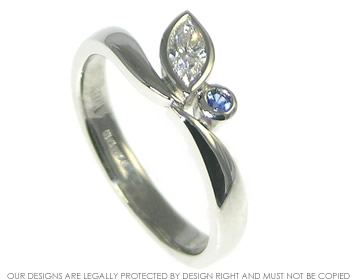 Butterfly inspired asymmetrical platinum, 0.26ct diamond and sapphire engagement ring