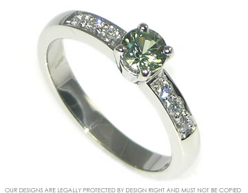 Phoebe's platinum and green sapphire engagment ring with six diamonds