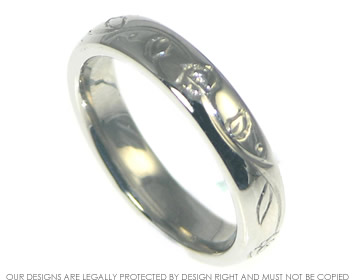 Palladium wedding ring with rose and leaf vine engraving.