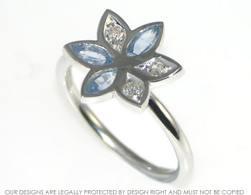 Modern daisy cluster with marquise cut pale blue sapphires and recycled diamonds