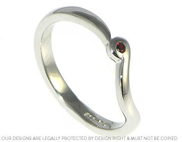 A delicate fitted wedding ring with garnet