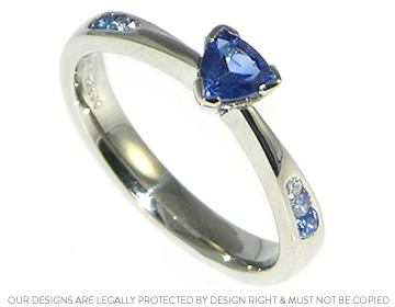 Rich blue  trillant sapphire bespoke engagement ring