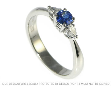 A delicate sapphire and diamond trilogy engagement ring