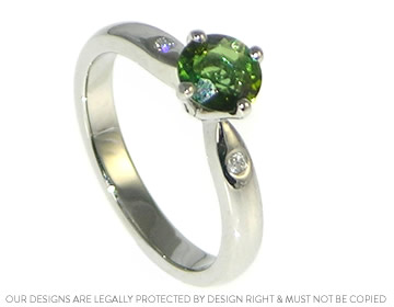 Simple platinum, bright green tourmaline and diamond engagement ring