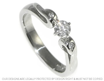 Solitaire diamond engagement ring with pair grain set diamonds