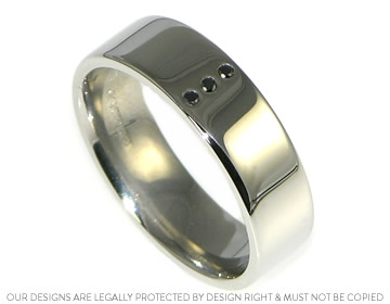 A man's enagagement ring with heat treated black diamonds.