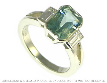 Dramatic white gold engagement ring with an emerald cut aquamarine