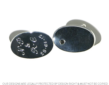 A pair of silver oval cufflinks with 2mm facetted onyx and engraved details 