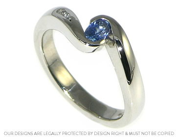 Twist style oval mid-blue sapphire, diamond and palladium engagement ring