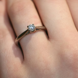 crossover setting diamond solitaire engagement ring in 18ct fairtrade gold