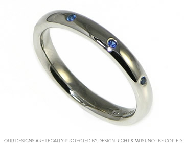 Handcrafted bespoke wedding ring with crisp blue sapphires