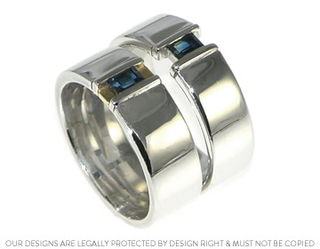 Mixed metal commitment rings with a medium blue sapphire in a modern design 