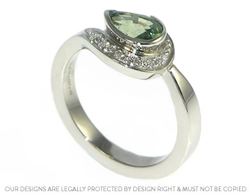 Palladium engagement ring with a pear shaped green sapphire