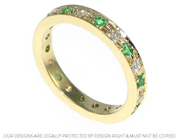 Carolyn's diamond and emerald yellow gold eternity ring