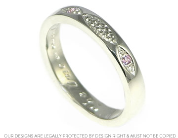 Hazel's bespoke wedding ring with pink sapphires and engraved detail