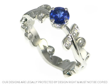 Platinum vine inspired ring with a bright blue  sapphire